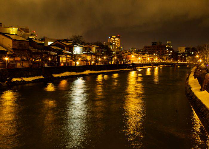 The spectacle of Kanazawa's Asano River at night, lit up by the streetlights along its banks.